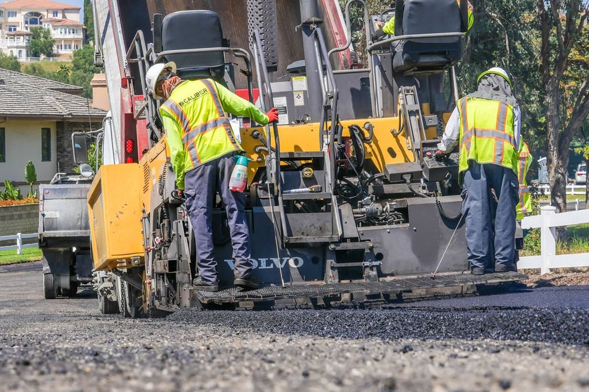 Caliber Paving crew laying asphalt with a paver